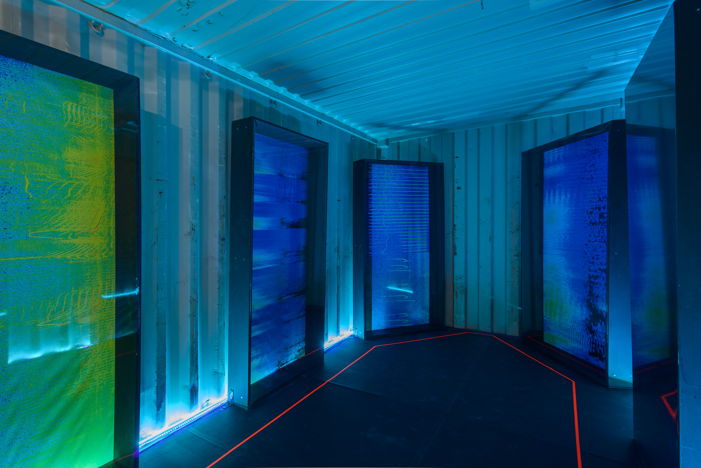 Container interior with four panels, blue and green spectrograms.